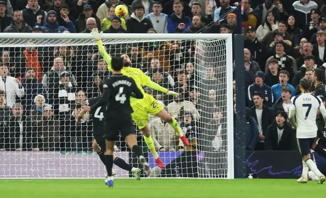 Manchester City's goalkeeper Gianluigi Donnarumma, top, fails to stop a shot by Tottenham's Dominic Solanke to score the second goal during the English Premier League soccer match between Tottenham Hotspur and Manchester City in London, Sunday, Feb. 1, 2026. (AP Photo/Richard Pelham)