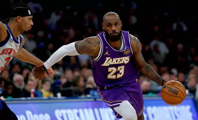 New York Knicks guard Josh Hart, left, defends against Los Angeles Lakers forward LeBron James, right, during the second half of an NBA basketball game, Sunday, Feb. 1, 2026, in New York. (AP Photo/John Munson)