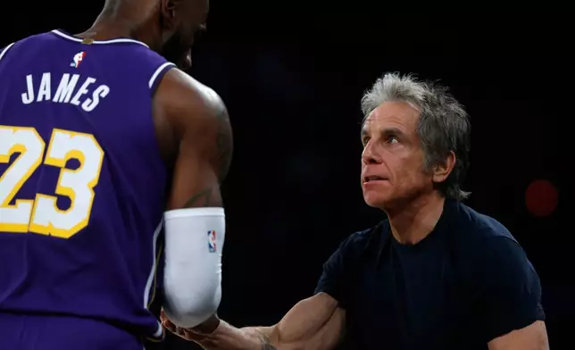 Los Angeles Lakers forward LeBron James, left, talks with actor Ben Stiller during the first half of an NBA basketball game, Sunday, Feb. 1, 2026, in New York. (AP Photo/John Munson)