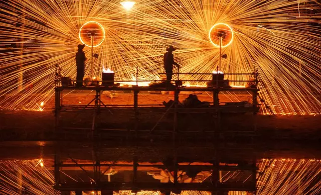 FILE - A Chinese folk performance known as da shuhua, or molten iron fireworks, is made ahead of Lunar New Year celebrations in Beijing, China, Feb. 9, 2026. (AP Photo/Vincent Thian, File)