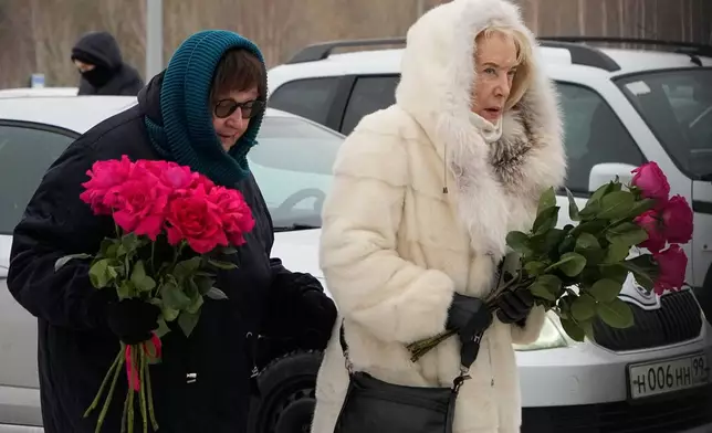 Late Russian opposition leader Alexei Navalny's mother Lyudmila Navalnaya, left, and his mother-in-law Alla Abrosimova, walk to lay flowers at his grave, two years after his death, at the Borisovskoye Cemetery in Moscow, on Monday, Feb. 16, 2026. (AP Photo/Alexander Zemlianichenko)