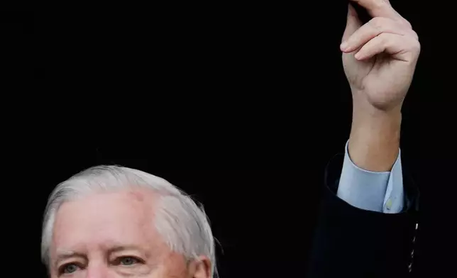 United States Senator Lindsey Graham , SC, waves to supports of Iran's exiled Crown Prince Reza Pahlavi at a demonstration during the Munich Security Conference in Munich, Germany, Saturday, Feb. 14, 2026. (AP Photo/Ebrahim Noroozi)