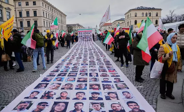 Supporters of the Iranian opposition organisation People's Mujahedeen Organisation of Iran, PMOI, also known as the Mujahedeen-e-Khalq, MEK, show posters of people, they said was killed during the protests in Iran, at a demonstration during the Munich Security Conference in Munich, Germany, Friday, Feb. 13, 2026. (AP Photo/Ebrahim Noroozi)