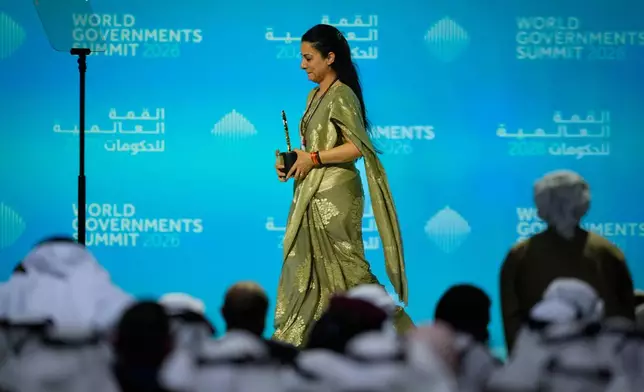 Indian teacher Rouble Nagi walks off the stage after receiving the Global Teacher Prize trophy from Dubai Crown Prince Sheikh Hamdan bin Mohammed Al Maktoum at a ceremony in Dubai, United Arab Emirates, Thursday, Feb. 5, 2026. (AP Photo/Altaf Qadri)