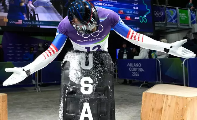 United States' Austin Florian arrives at the finish during a men's skeleton run at the 2026 Winter Olympics, in Cortina d'Ampezzo, Italy, Friday, Feb. 13, 2026. (AP Photo/Alessandra Tarantino)