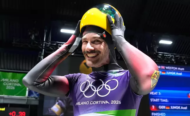 Germany's Axel Jungk arrives at the finish during a men's skeleton run at the 2026 Winter Olympics, in Cortina d'Ampezzo, Italy, Friday, Feb. 13, 2026. (AP Photo/Alessandra Tarantino)
