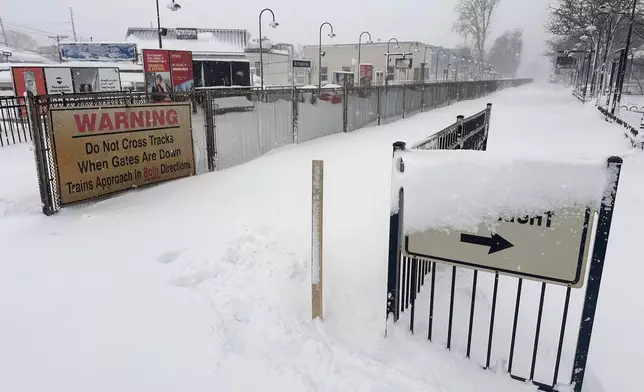 Snow covers a path at a train station in Rutherford, N.J., Monday, Feb. 23, 2026 after an intense snowstorm hit the area. (AP Photo/Ted Shaffrey)