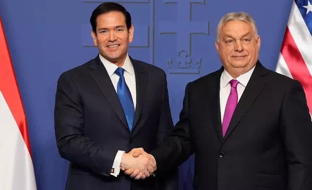 U.S. Secretary of State Marco Rubio, left, and Hungary's Prime Minister Viktor Orban shake hands after a news conference in Budapest, Hungary, Monday, Feb. 16, 2026. (AP Photo/Alex Brandon, Pool)