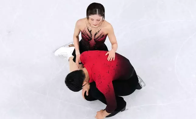 Riku Miura and Ryuichi Kihara of Japan react after competing during the pairs figure skating short program at the 2026 Winter Olympics, in Milan, Italy, Sunday, Feb. 15, 2026. (AP Photo/Bernat Armangue)