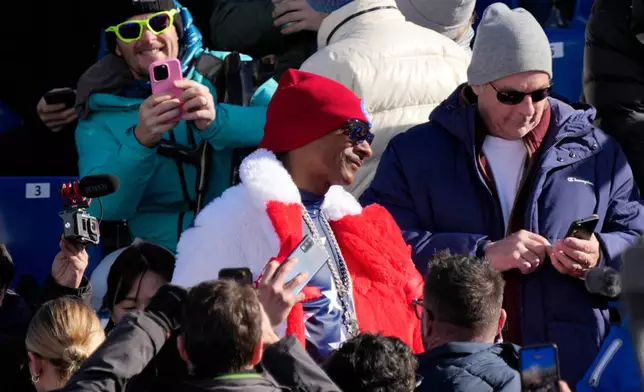 Snoop Dogg in the stands at the finish area of an alpine ski women's downhill race, at the 2026 Winter Olympics, in Cortina d'Ampezzo, Italy, Sunday, Feb. 8, 2026. (AP Photo/Andy Wong)