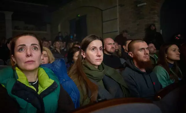 Viewers react to the premiere of an adaptation of Ivan Kotliarevskyi’s “Eneida,” a Ukrainian reimagining of Virgil’s “Aeneid,” performed by war veterans, many of whom sustained severe injuries in combat during Russia's full-scale invasion of Ukraine, in Kyiv, Ukraine, Thursday, Feb. 19, 2026. (AP Photo/Efrem Lukatsky)