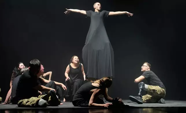 Ukrainian war veterans, many of whom sustained severe injuries in combat during Russia's full-scale invasion of Ukraine, perform during a premiere on Thursday, Feb. 19, 2026, in Kyiv, Ukraine. (AP Photo/Efrem Lukatsky)