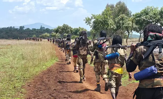 Oromo Liberation Army (OLA) fighters walk single file carrying rifles in Oromia, Ethiopia, June 2, 2025. (AP Photo)