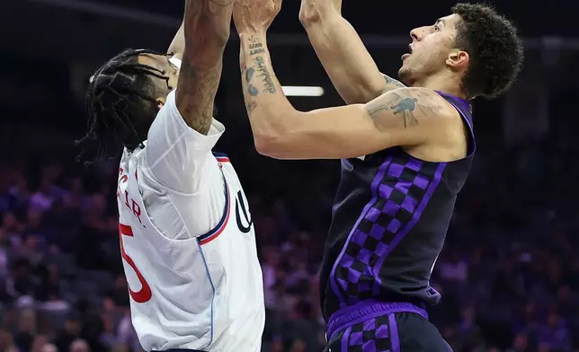 Sacramento Kings guard Nique Clifford, right, goes up to shoot with Los Angeles Clippers forward Derrick Jones Jr. defending during the first half of an NBA basketball game Friday, Feb. 6, 2026, in Sacramento, Calif. (AP Photo/Sara Nevis)