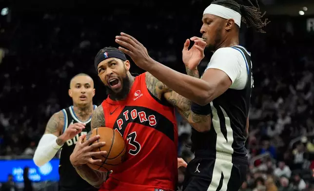 Toronto Raptors' Brandon Ingram, front left, drives to the basket against Milwaukee Bucks' Myles Turner, right, during the first half of an NBA basketball game Sunday, Feb. 22, 2026, in Milwaukee. (AP Photo/Aaron Gash)