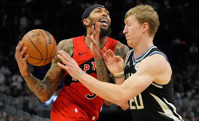 Toronto Raptors' Brandon Ingram drives to the basket against Milwaukee Bucks' AJ Green during the first half of an NBA basketball game Sunday, Feb. 22, 2026, in Milwaukee. (AP Photo/Aaron Gash)