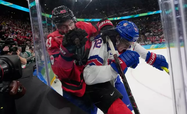 Canada's Tom Wilson (43) and United States' Tage Thompson (72) battle for the puck during the second period of a men's ice hockey gold medal game between Canada and the United States at the 2026 Winter Olympics, in Milan, Italy, Sunday, Feb. 22, 2026. (AP Photo/Petr David Josek)