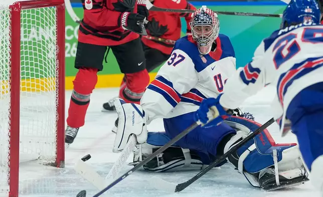 United States' Connor Hellebuyck (37) makes a stick save against Canada during the third period of a men's ice hockey gold medal game between Canada and the United States at the 2026 Winter Olympics, in Milan, Italy, Sunday, Feb. 22, 2026. (AP Photo/Petr David Josek)