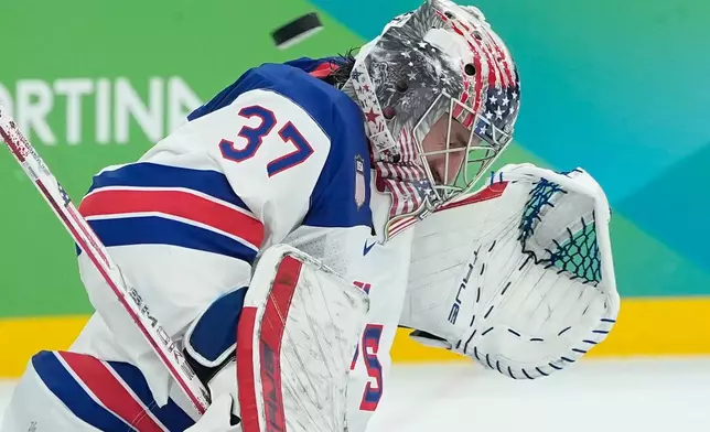 United States' Connor Hellebuyck (37) blocks a shot by Canada during a men's ice hockey gold medal game between Canada and the United States at the 2026 Winter Olympics, in Milan, Italy, Sunday, Feb. 22, 2026. (AP Photo/Petr David Josek)
