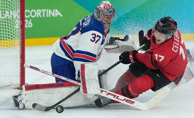 United States' Connor Hellebuyck (37) stops a shot attempt by Canada's Macklin Celebrini (17) during the third period of a men's ice hockey gold medal game between Canada and the United States at the 2026 Winter Olympics, in Milan, Italy, Sunday, Feb. 22, 2026. (AP Photo/Petr David Josek)