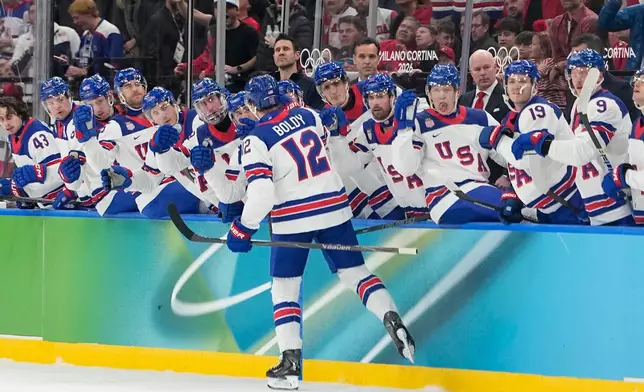 United States' Matt Boldy celebrates with teammates after scoring the opening goal during a men's ice hockey gold medal game between Canada and the United States at the 2026 Winter Olympics, in Milan, Italy, Sunday, Feb. 22, 2026. (AP Photo/Hassan Ammar)