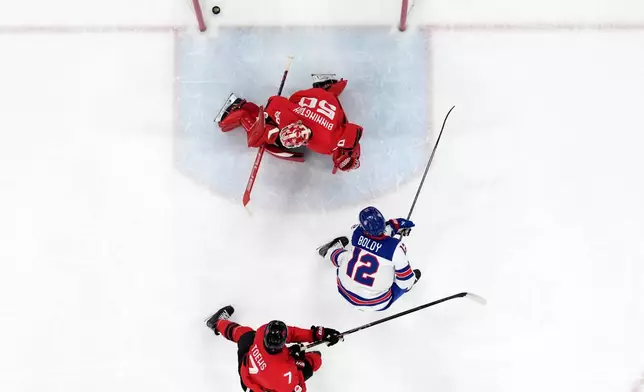 United States' Matt Boldy (12) scores his side's opening goal during a men's ice hockey gold medal game between Canada and the United States at the 2026 Winter Olympics, in Milan, Italy, Sunday, Feb. 22, 2026. (AP Photo/Nikos Seimenakis)