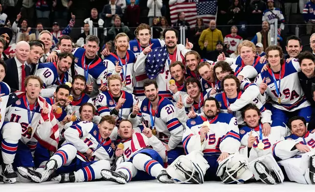Gold medalists of the United States pose after the men's ice hockey gold medal game between Canada and the United States at the 2026 Winter Olympics, in Milan, Italy, Sunday, Feb. 22, 2026. (AP Photo/Hassan Ammar)