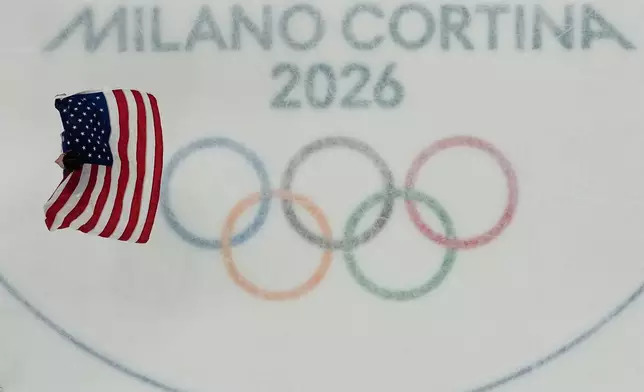 United States' goalie Connor Hellebuyck celebrates after the United States beat Canada in overtime in the men's gold medal hockey game at the 2026 Winter Olympics, in Milan, Italy, Sunday, Feb. 22, 2026. (AP Photo/David J. Phillip)