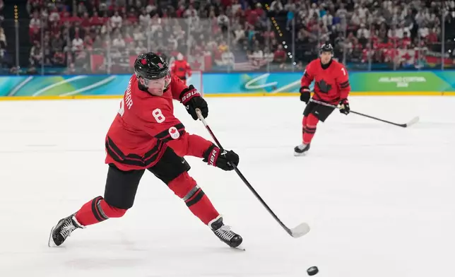 Canada's Cale Makar (8) scores during a men's ice hockey gold medal game between Canada and the United States at the 2026 Winter Olympics, in Milan, Italy, Sunday, Feb. 22, 2026. (AP Photo/Hassan Ammar)