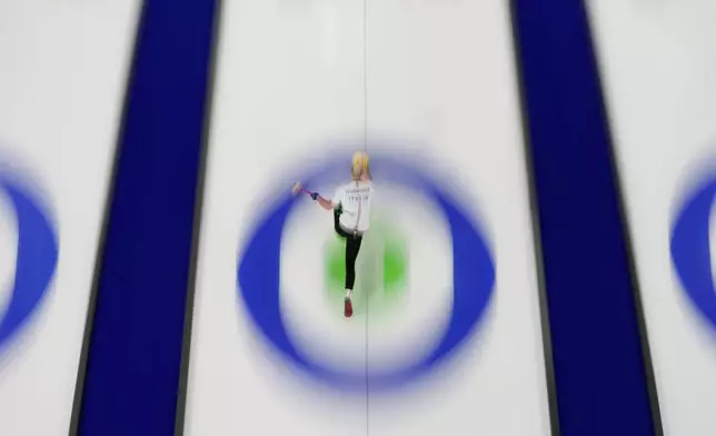 Italy's Amos Mosaner delivers a stone against the United States during a curling mixed doubles round robin session at the 2026 Winter Olympics, in Cortina d'Ampezzo, Italy, Friday, Feb. 6, 2026. (AP Photo/David J. Phillip)