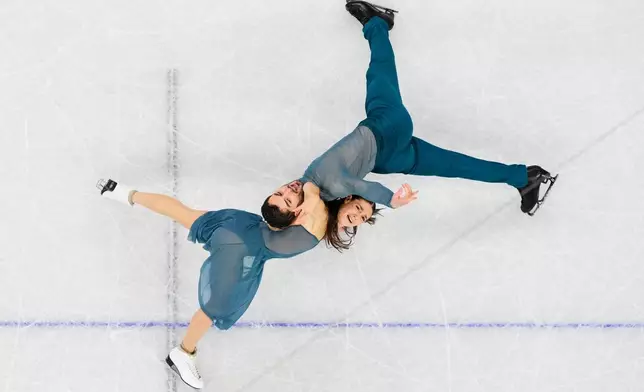 Laurence Fournier Beaudry and Guillaume Cizeron of France compete during the ice dancing free skate in figure skating at the 2026 Winter Olympics, in Milan, Italy, Wednesday, Feb. 11, 2026. (AP Photo/Bernat Armangue)