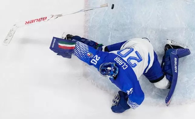 Italy's goalkeeper Damian Clara fails to make a save during a preliminary round game of men's ice hockey between Finland and Italy at the 2026 Winter Olympics, in Milan, Italy, Saturday, Feb. 14, 2026. (AP Photo/Petr David Josek)