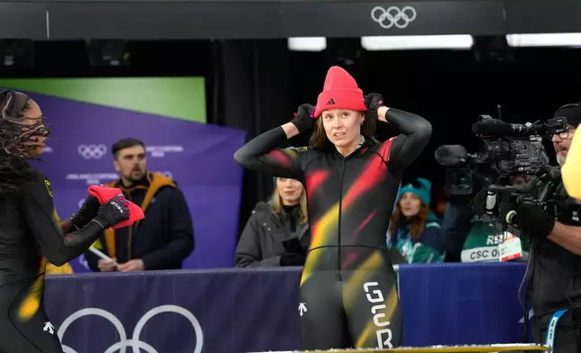 Germany's Laura Nolte reacts as she arrives at the finish during a two women bobsled run at the 2026 Winter Olympics, in Cortina d'Ampezzo, Italy, Friday, Feb. 20, 2026. (AP Photo/Alessandra Tarantino)