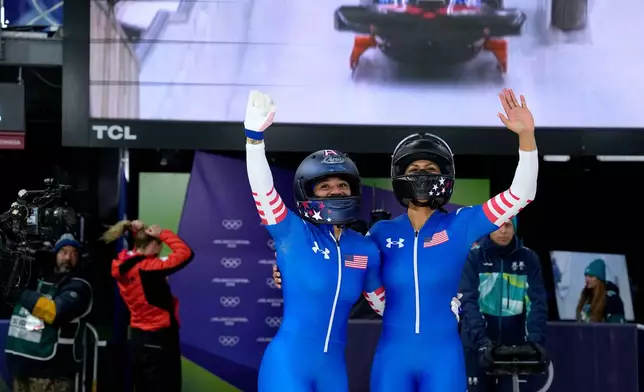 United States' Kaysha Love, right, and Azaria Hill react at the finish during a two women bobsled run at the 2026 Winter Olympics, in Cortina d'Ampezzo, Italy, Friday, Feb. 20, 2026. (AP Photo/Alessandra Tarantino)