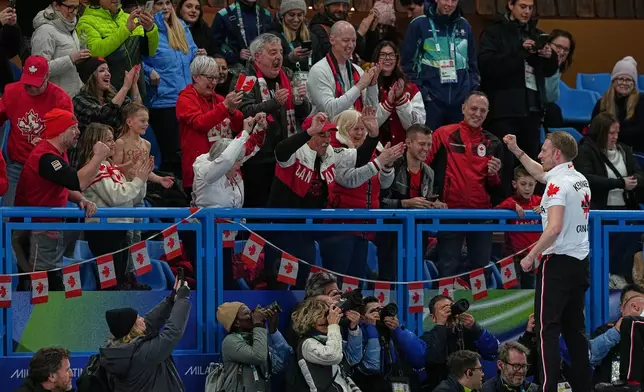 Canada's Marc Kennedy celebrates with fans after defeating Britain in a men's curling gold medal match, at the 2026 Winter Olympics, in Cortina d'Ampezzo, Italy, Saturday, Feb. 21, 2026. (AP Photo/Fatima Shbair)
