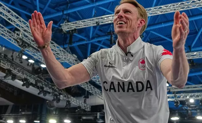 Canada's Marc Kennedy celebrates defeating Britain in a men's curling gold medal match, at the 2026 Winter Olympics, in Cortina d'Ampezzo, Italy, Saturday, Feb. 21, 2026. (AP Photo/Misper Apawu)