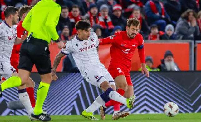 Bologna's Santiago Castro and Brann's Fredrik Pallesen Knudsen, right, in action during the Europa League soccer match between SK Brann and Bologna, in Bergen, Norway, Thursday Feb. 19, 2026. (Paul S. Amundsen/NTB via AP)