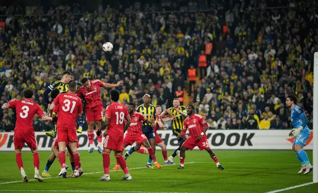 Nottingham Forest's Murillo, center, defends a high ball during a Europa league play-off first leg soccer match between Fenerbahce and Nottingham Forest in Istanbul, Turkey, Thursday, Feb. 19, 2026. (AP Photo/Emrah Gurel)