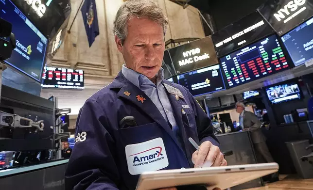 Trader Robert Charmak works on the floor of the New York Stock Exchange, Monday, Feb. 2, 2026. (AP Photo/Richard Drew)