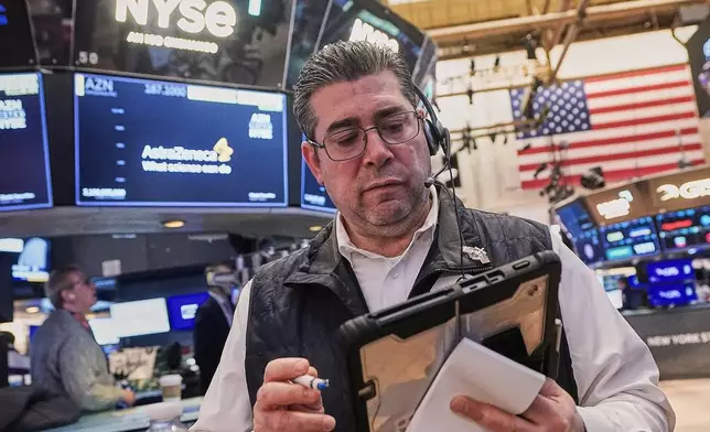 Trader Michael Capolino works on the floor of the New York Stock Exchange, Monday, Feb. 2, 2026. (AP Photo/Richard Drew)