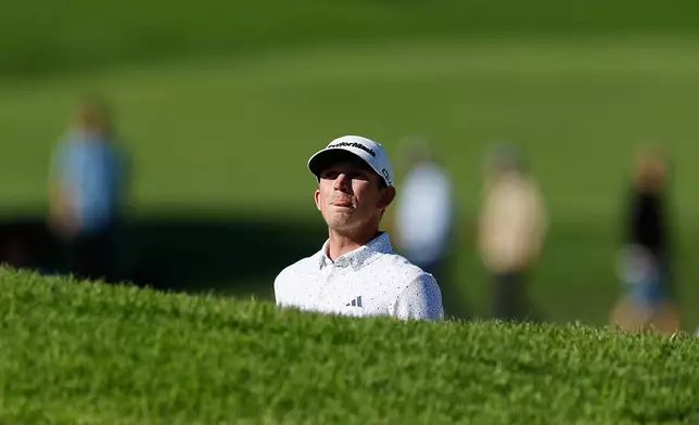 Jacob Bridgeman prepares to hit from a bunker on the 14th hole during the third round of the Genesis Invitational golf tournament at Riviera Country Club, Saturday, Feb. 21, 2026, in the Pacific Palisades area of Los Angeles. (AP Photo/Caroline Brehman )