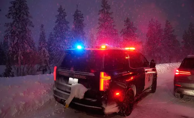 A California Highway Patrol vehicle is parked along a road during a snow storm Wednesday, Feb. 18, 2026, in Placer County, Calf. (AP Photo/Godofredo A. Vásquez)