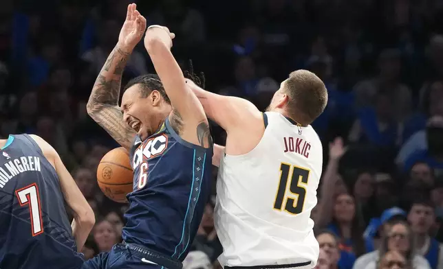 Oklahoma City Thunder forward Jaylin Williams (6) falls into Denver Nuggets center Nikola Jokic (15) as he goes after a rebound during the second half of an NBA basketball game, Friday, Feb. 27, 2026, in Oklahoma City. (AP Photo/Kyle Phillips)