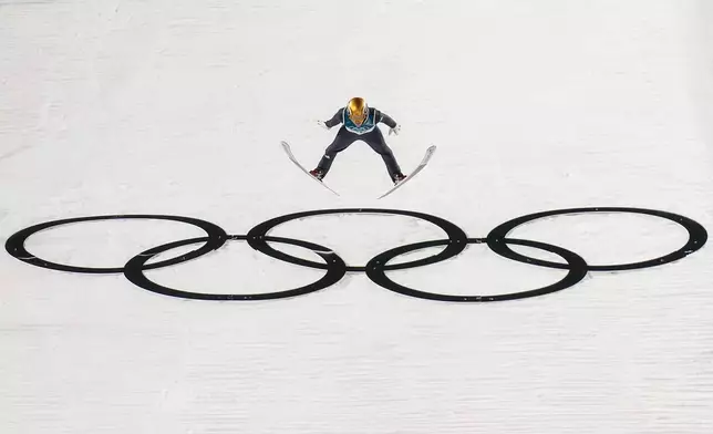 Philipp Raimund, of Germany, soars through the air during his final round jump in the ski jumping men's normal hill individual at the 2026 Winter Olympics, in Predazzo, Italy, Monday, Feb. 9, 2026. (AP Photo/Evgeniy Maloletka)