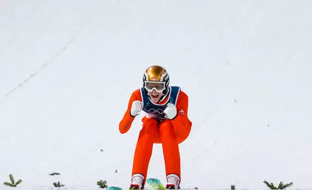 Gregor Deschwanden, of Switzerland, reacts after his first round jump of the ski jumping men's normal hill individual at the 2026 Winter Olympics, in Predazzo, Italy, Monday, Feb. 9, 2026. (AP Photo/Evgeniy Maloletka)