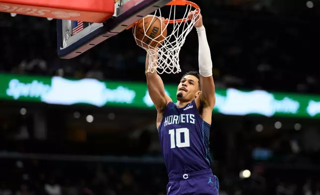 Charlotte Hornets guard Josh Green dunks during the first half of an NBA basketball game against the Washington Wizards, Sunday, Feb. 22, 2026, in Washington. (AP Photo/Nick Wass)
