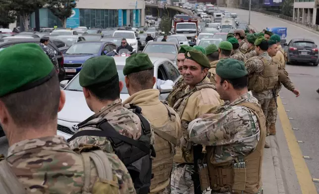 Lebanese army soldiers deploy after taxi drivers block a main highway with their cars during a protest against the increased taxes and gasoline prices issued by the Lebanese Cabinet on Monday, in Beirut, Lebanon, Tuesday, Feb. 17, 2026. (AP Photo/Hussein Malla)