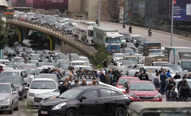 Taxi drivers, foreground, block a main highway with their cars during a protest against the increased taxes and gasoline prices issued by the Lebanese Cabinet on Monday, in Beirut, Lebanon, Tuesday, Feb. 17, 2026. (AP Photo/Hussein Malla)