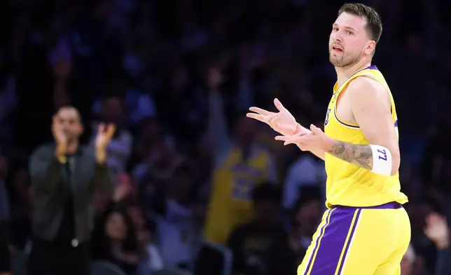 Los Angeles Lakers guard Luka Doncic gestures after scoring a 3-point basket against the Los Angeles Clippers during the first half of an NBA basketball game, Friday, Feb. 20, 2026, in Los Angeles. (AP Photo/Jessie Alcheh)