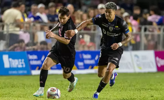 Inter Miami's Lionel Messi competes for the ball with Ronald Briones of Ecuador's Independiente del Valle during an international friendly soccer match in Bayamon, Puerto Rico, Thursday, Feb. 26, 2026. (AP Photo/Alejandro Granadillo)